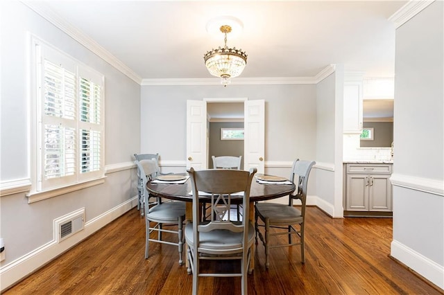2197 Fairway Cir NE, Brookhaven, GA 30319 - dining space featuring dark wood-style flooring, plenty of natural light, crown molding, a chandelier, and baseboards