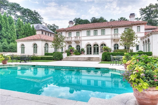 back of property featuring a patio and a balcony