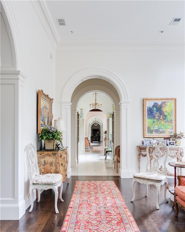 hall featuring hardwood / wood-style floors and ornamental molding