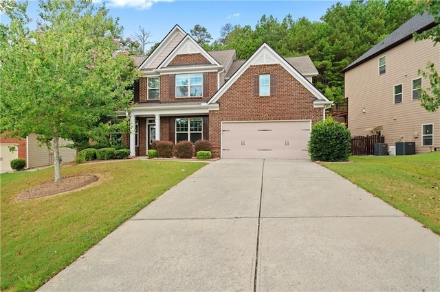 craftsman house with a garage, cooling unit, and a front lawn