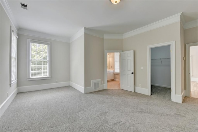 unfurnished bedroom featuring crown molding, visible vents, and carpet flooring