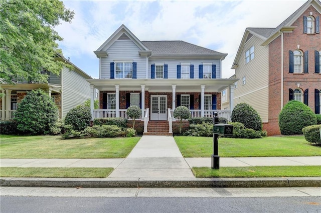 view of front of property with brick siding, a porch, and a front yard