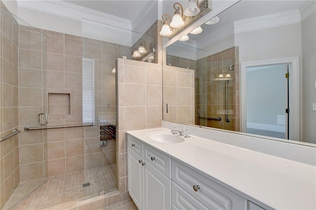 bathroom with ornamental molding, a stall shower, and vanity