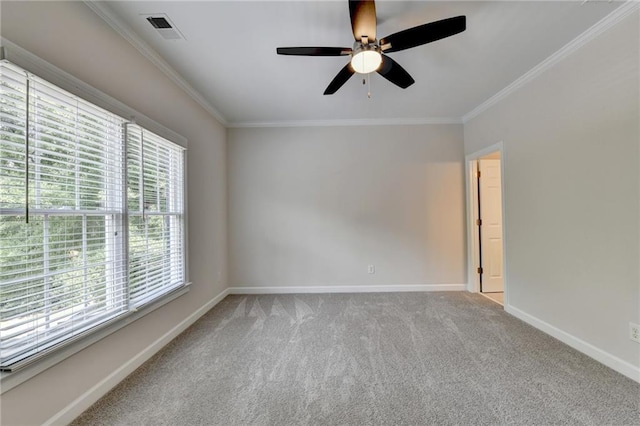 empty room with carpet floors, baseboards, visible vents, and ornamental molding