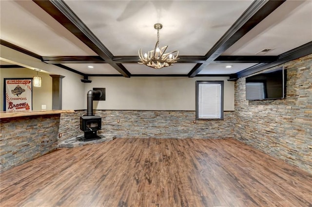 unfurnished living room featuring coffered ceiling, wood finished floors, and beam ceiling