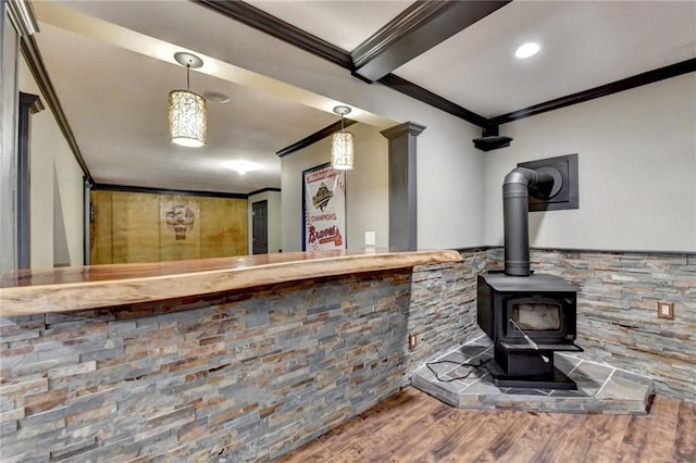 interior space with a wood stove and a bar