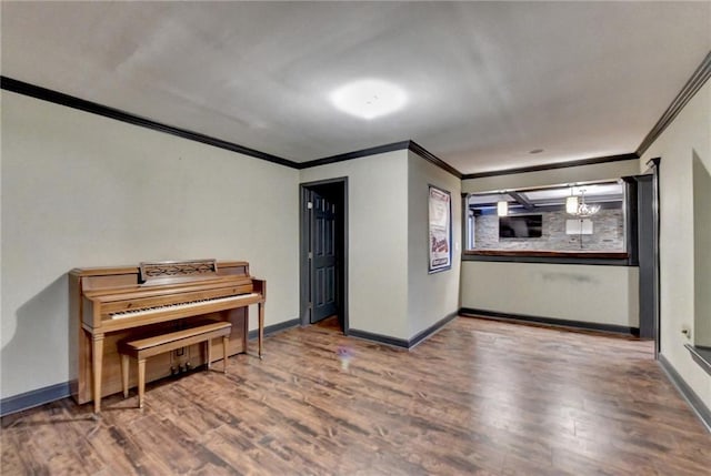 interior space featuring ornamental molding, baseboards, and wood finished floors