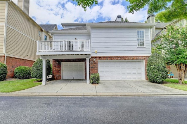 view of front of house featuring concrete driveway, brick siding, and an attached garage