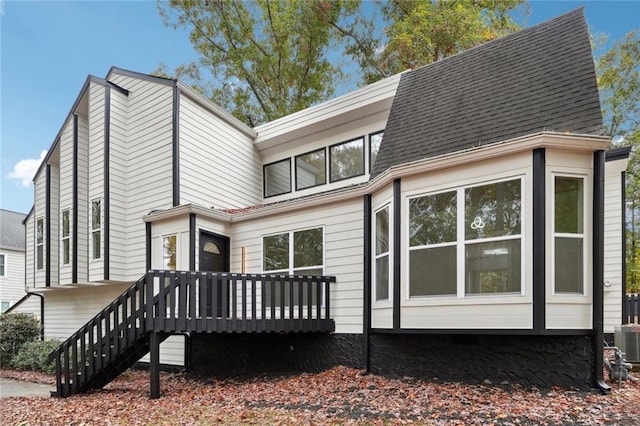 back of property featuring a wooden deck