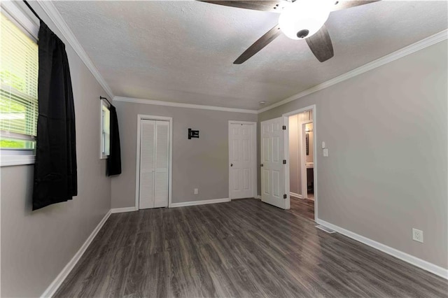 unfurnished bedroom with baseboards, a textured ceiling, and dark wood-style floors
