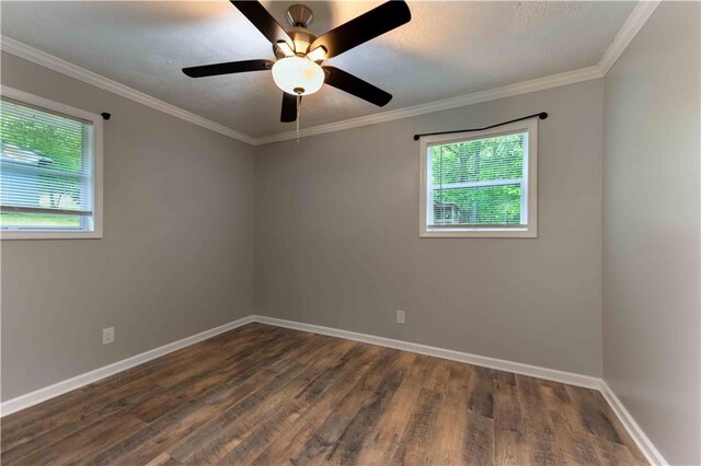 empty room with baseboards, ornamental molding, and dark wood-type flooring