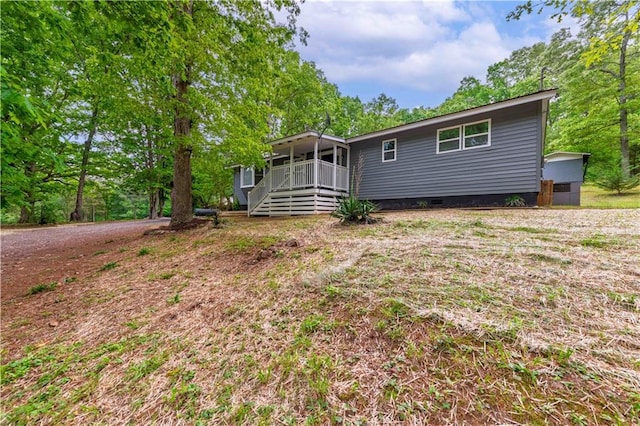 exterior space with crawl space and a wooden deck