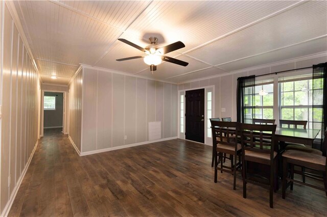 dining room with dark wood-style flooring, ceiling fan, ornamental molding, and baseboards