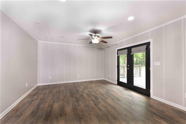 spare room featuring crown molding, baseboards, ceiling fan, french doors, and dark wood finished floors