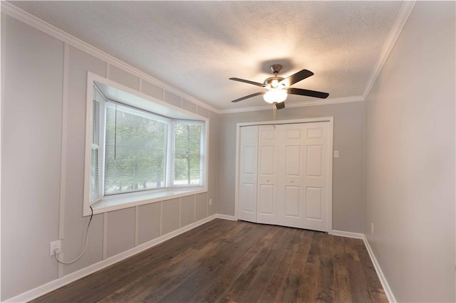 unfurnished bedroom with crown molding, a closet, dark wood finished floors, and a textured ceiling