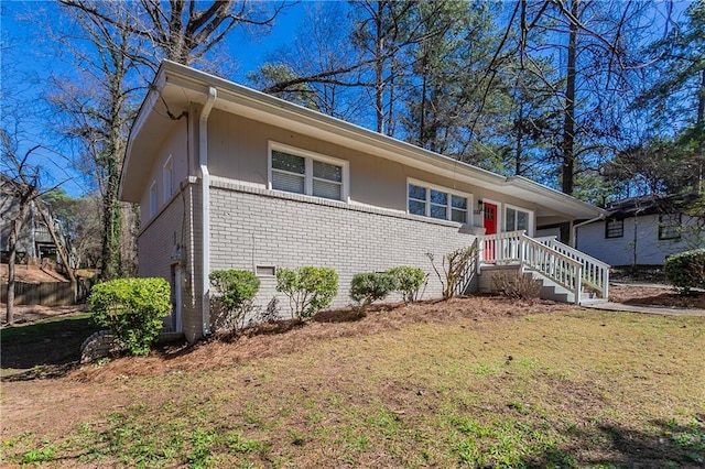 ranch-style home with crawl space, brick siding, and a front lawn