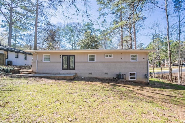 rear view of house with a wooden deck, central AC, french doors, crawl space, and brick siding