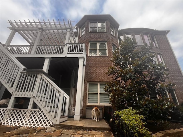 7113 Artisans Way, Flowery Branch, GA 30542 - back of property with stairs, brick siding, and a pergola