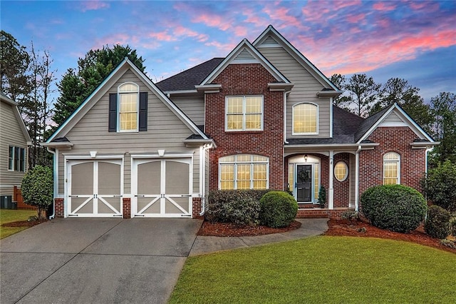 view of front of home featuring a garage and a yard