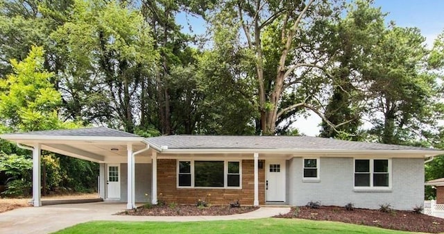 ranch-style house with a front yard and a carport