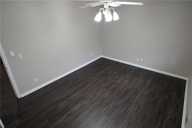 empty room featuring dark wood-type flooring and ceiling fan