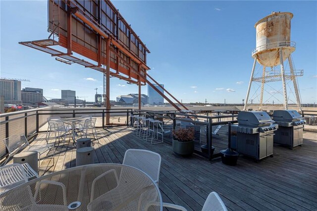 wooden deck featuring a grill