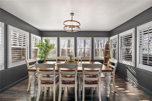 dining space with dark wood-style flooring