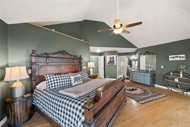 bedroom featuring ceiling fan, hardwood / wood-style flooring, and lofted ceiling