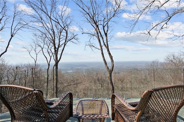 wooden terrace featuring a view of trees