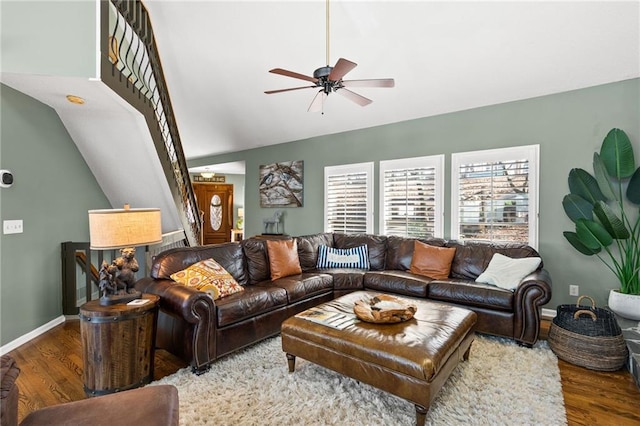 living room with lofted ceiling, baseboards, a ceiling fan, and wood finished floors