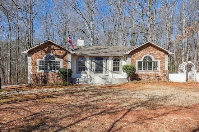 ranch-style house featuring a chimney