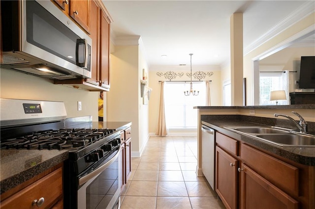 401 Oscar Way, Dallas, GA 30132 - kitchen featuring appliances with stainless steel finishes, brown cabinets, a chandelier, crown molding, and light tile patterned floors