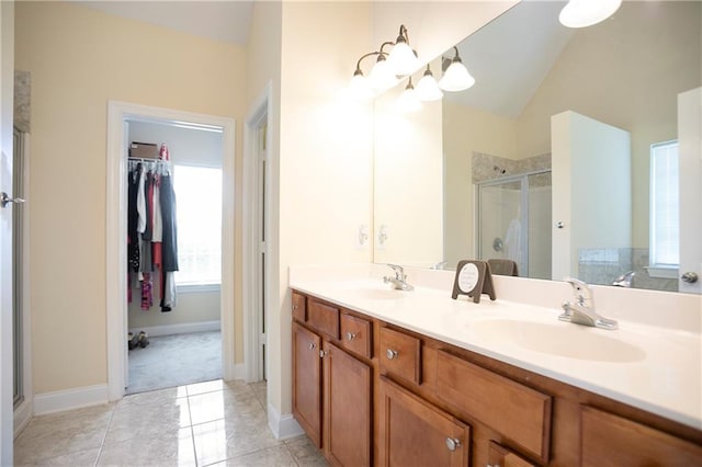 401 Oscar Way, Dallas, GA 30132 - full bath featuring a stall shower, a spacious closet, double vanity, lofted ceiling, and tile patterned flooring