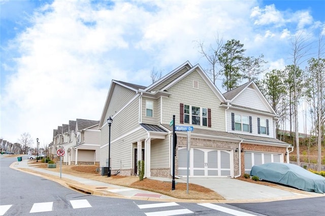 view of front of house with a garage and central air condition unit