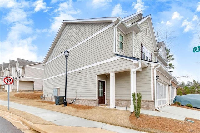 view of home's exterior featuring cooling unit and a garage