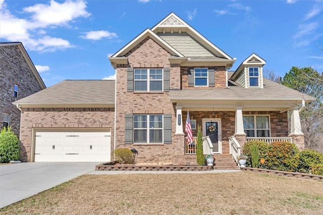 craftsman-style house featuring a garage, a front lawn, and covered porch