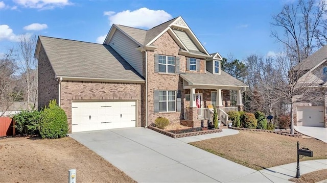 craftsman house featuring a porch, a garage, and a front lawn