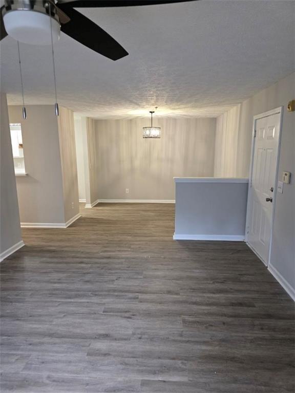 3201 Fairington Dr, Lithonia, GA 30038 - empty room featuring wood finished floors, ceiling fan, baseboards, and a textured ceiling
