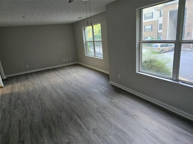 3201 Fairington Dr, Lithonia, GA 30038 - unfurnished room featuring dark wood-style flooring, baseboards, a ceiling fan, and a textured ceiling