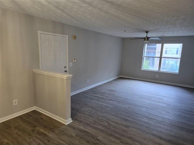 3201 Fairington Dr, Lithonia, GA 30038 - spare room featuring a textured ceiling, a ceiling fan, dark wood-style floors, and baseboards