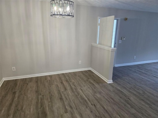 3201 Fairington Dr, Lithonia, GA 30038 - unfurnished dining area featuring a chandelier, dark wood-type flooring, and baseboards