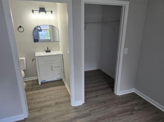 3201 Fairington Dr, Lithonia, GA 30038 - bathroom featuring wood finished floors, toilet, vanity, and baseboards