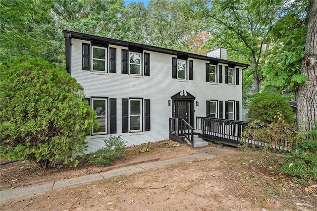 colonial house featuring a wooden deck