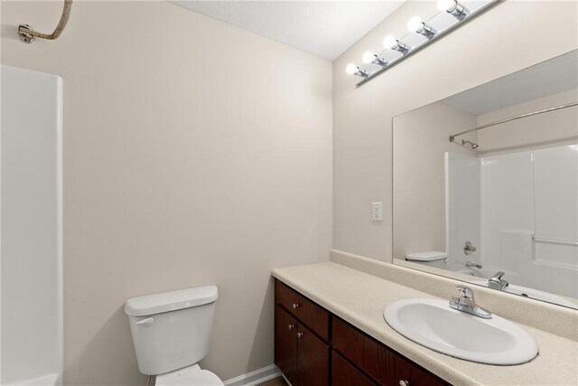 clothes washing area with laundry area, hookup for a washing machine, baseboards, and dark wood finished floors