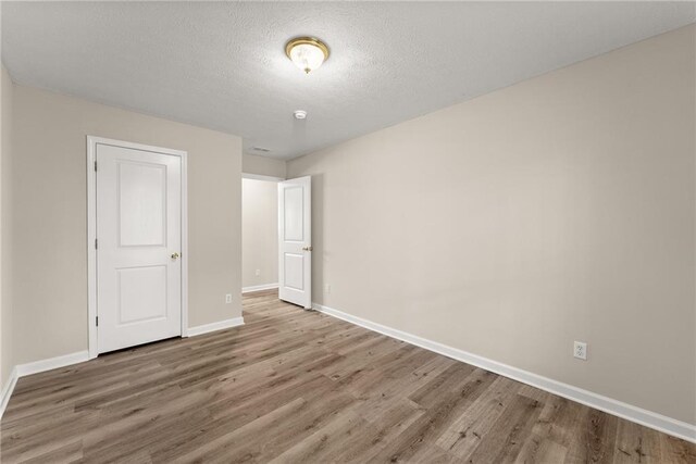 bathroom with visible vents, wood finished floors, toilet, and baseboards