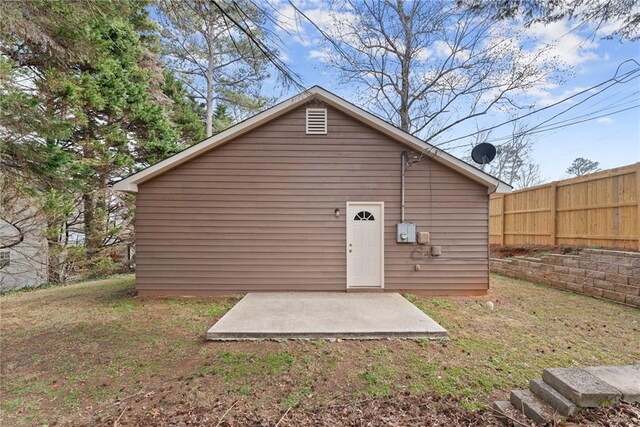 rear view of house featuring fence