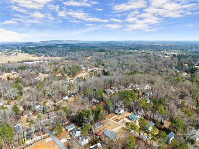 drone / aerial view featuring a water view and a wooded view