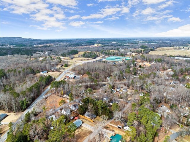 birds eye view of property with a forest view