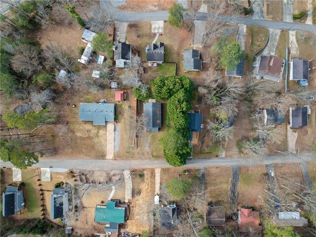 birds eye view of property with a wooded view and a mountain view