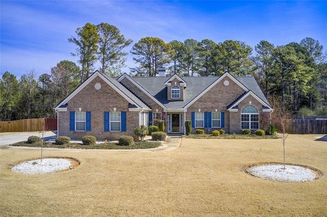 view of front facade with brick siding and fence